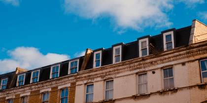 UK homes under cloudy blue sky