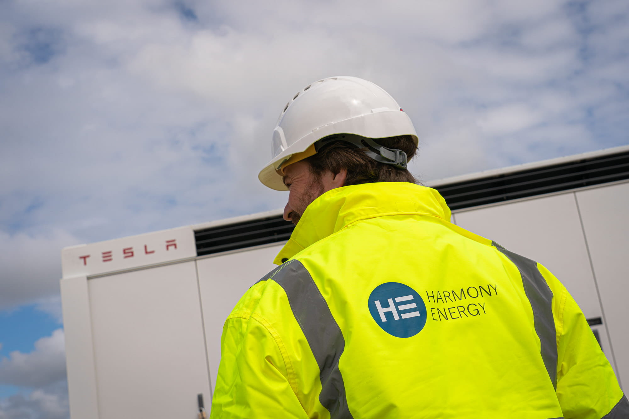 A worker in a hi vis jacket and helmet