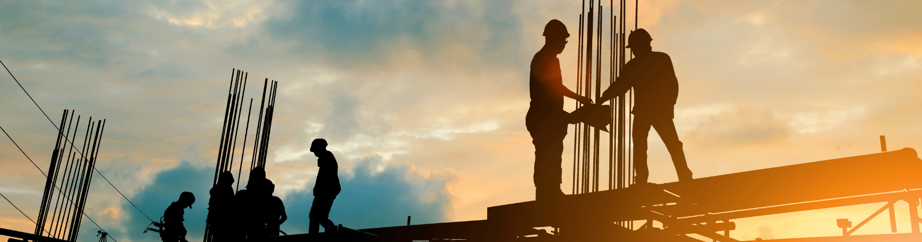 Silhouette of engineer and construction team working at site over blurred background sunset